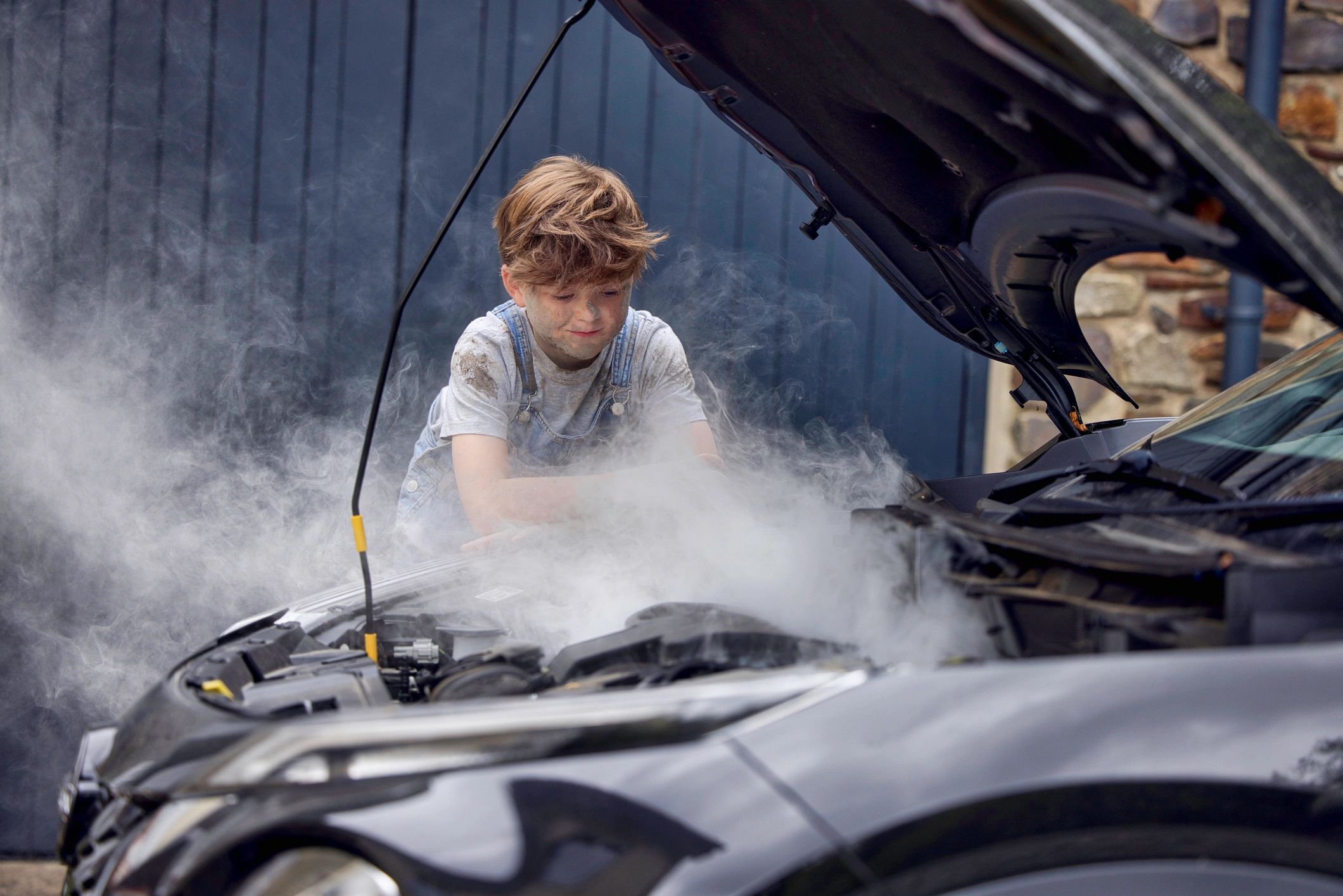 auto mechanic repairing car outdoors