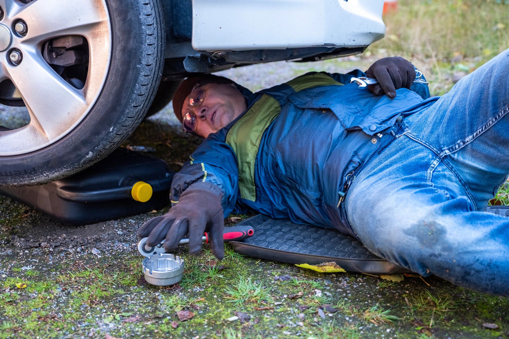 auto mechanic repairing car outdoors